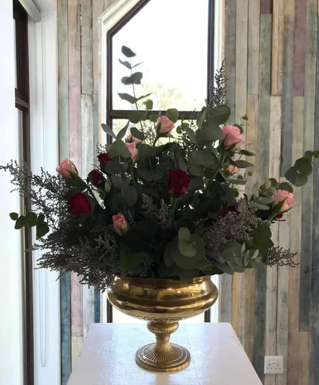 A statement floral arrangement in a gold urn